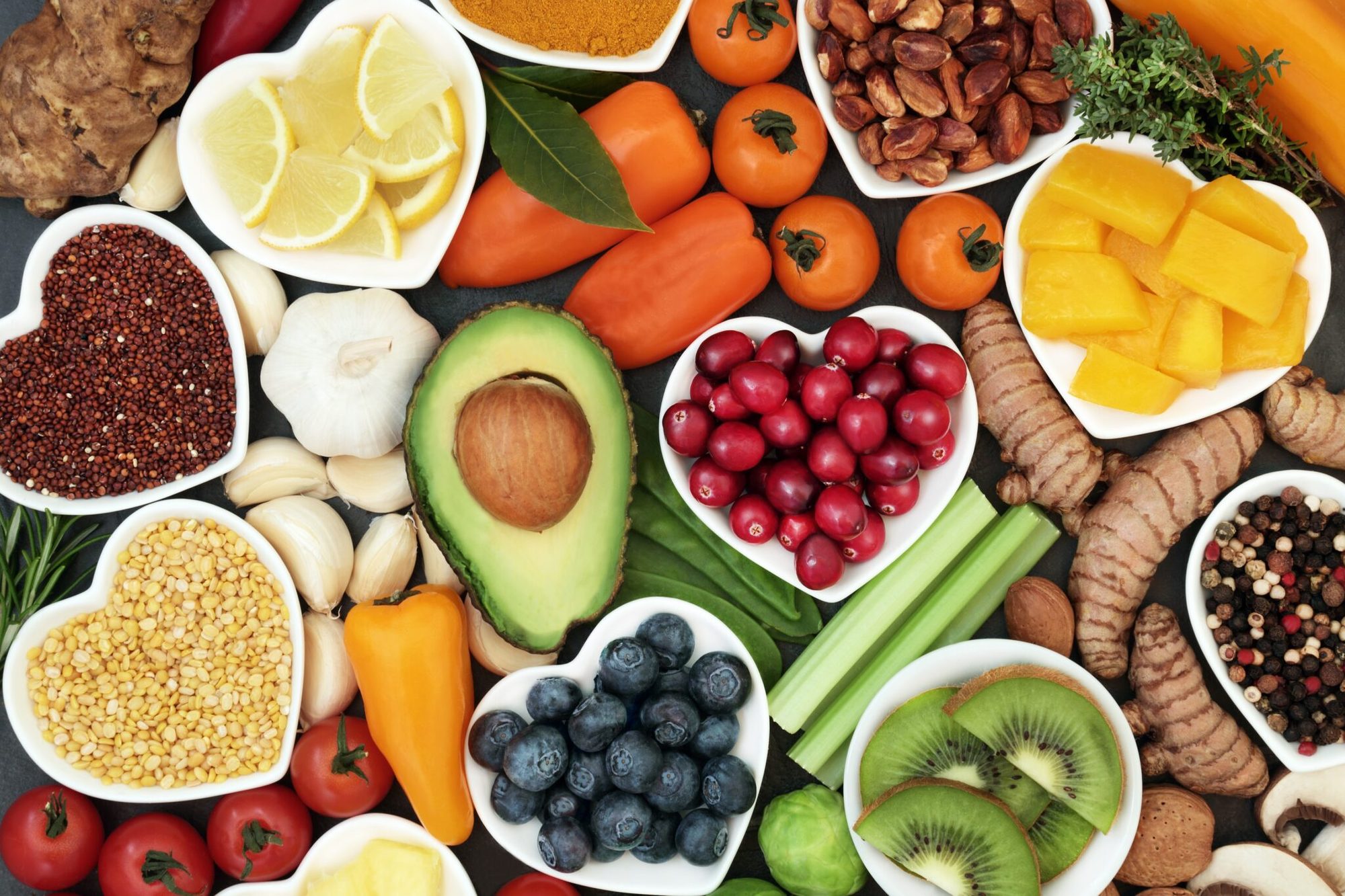 Bowls of fruit, vegetables, nuts and pulses laid out from above