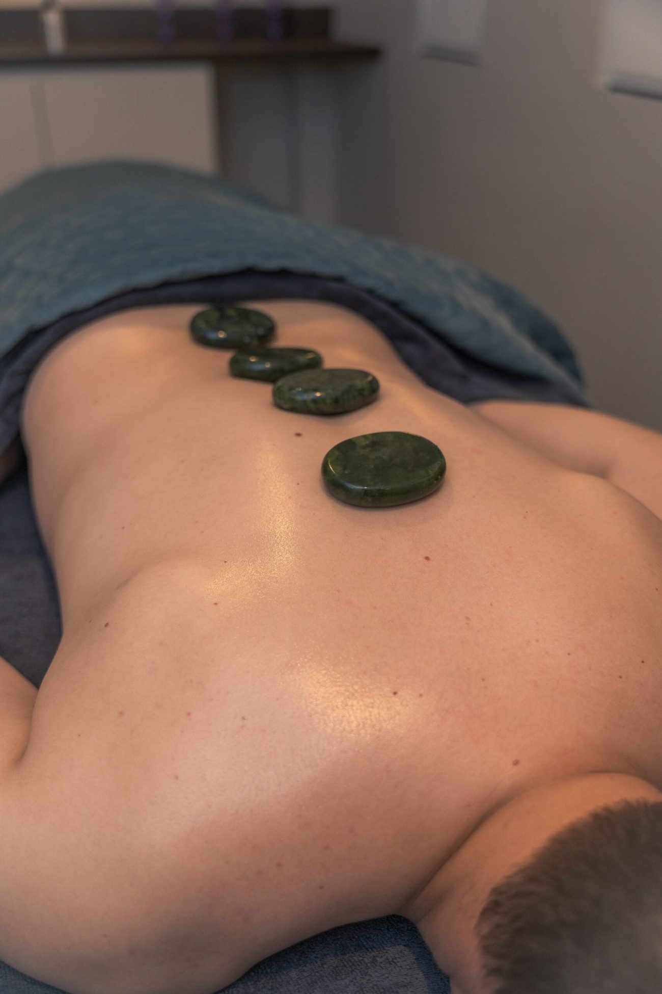 Hot stones laid along a client's back during a massage